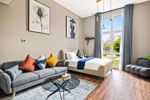 uma sala de estar com uma cama e um sofá em Luxury apartment at Discovery em Dubai