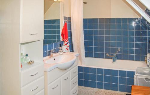 baño de azulejos azules con lavabo y bañera en Beautiful Home In Sydals With Kitchen en Høruphav