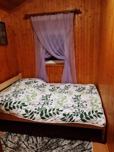 a bedroom with a bed with a canopy at Domek u Prezesa 