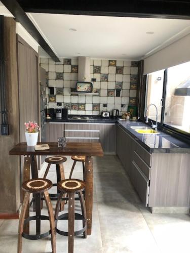 a kitchen with a table and two stools in it at Entrepinos in Mendoza