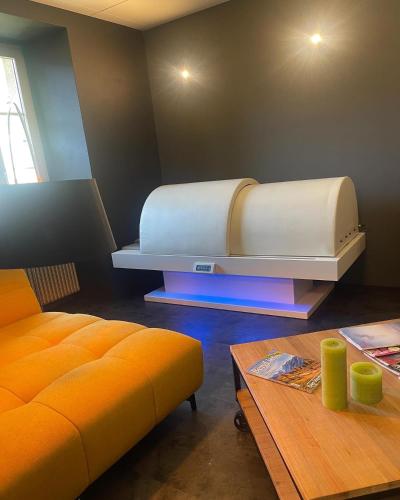 a room with a bed and a table and a couch at DU GLACIER Boutique & Traditions Hotel in Fiesch