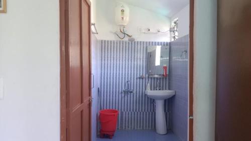 a small bathroom with a sink and a toilet at Villotale Khadait SH in Badīyārgaon