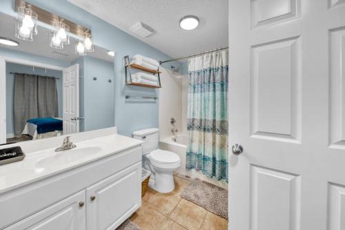a bathroom with a white sink and a toilet at Beachfront Condo #1413 Majestic Beach Resort in Panama City Beach