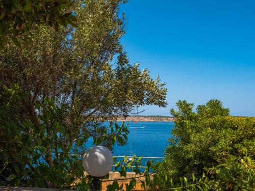 a view of a body of water through trees at Villa Palma - Sunset Sea Views with Pool, Jacuzzi, Sauna and Games Room in Mellieħa