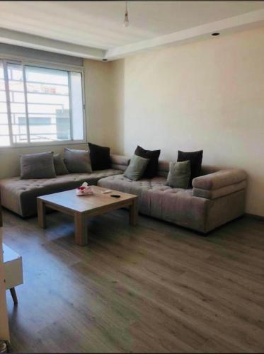 a living room with a couch and a coffee table at HASSAN in Rabat