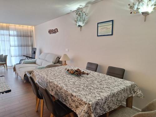 a living room with a table and a couch at Coliseum Residence in Ponta Delgada