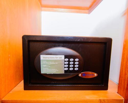a small television sitting on top of a wooden shelf at Best Western Dodoma City Hotel in Dodoma
