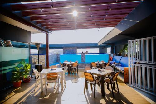 a patio with tables and chairs on a balcony at Best Western Dodoma City Hotel in Dodoma