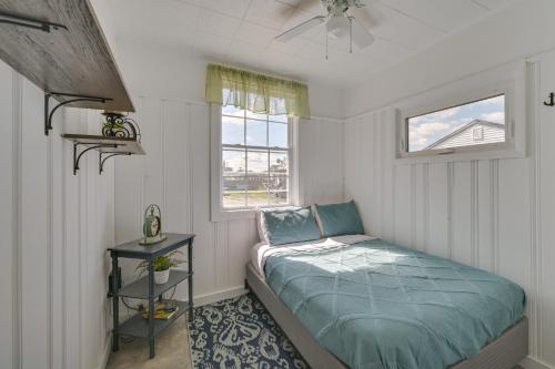 a small bedroom with a bed and a window at Cozy Hampton Vacation Rental, Walk to Beach! in Hampton