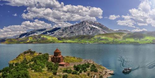 an island in the middle of a lake with a mountain at VILLA VIP in Sevan