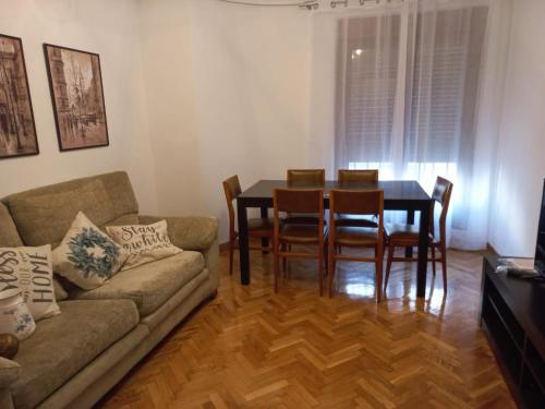 uma sala de estar com um sofá, uma mesa e cadeiras em CASA ESQUILAS em Ávila