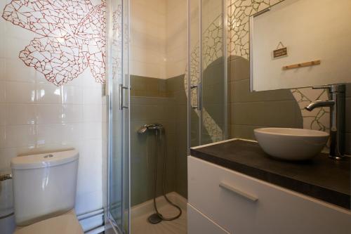 a bathroom with a toilet and a sink and a shower at Studio Villard De Lans in Villard-de-Lans