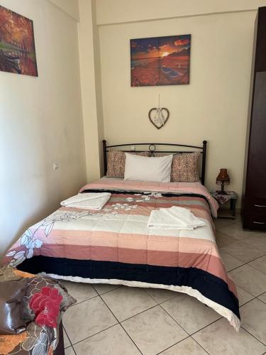 a bedroom with a bed in a room at See and City Apartment in Aigio