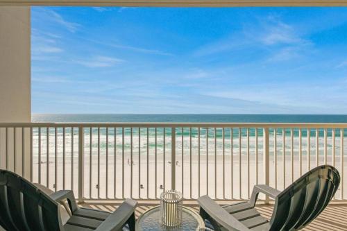 a balcony with a table and chairs and the beach at Beachfront Studio #1112 at Majestic in Panama City Beach