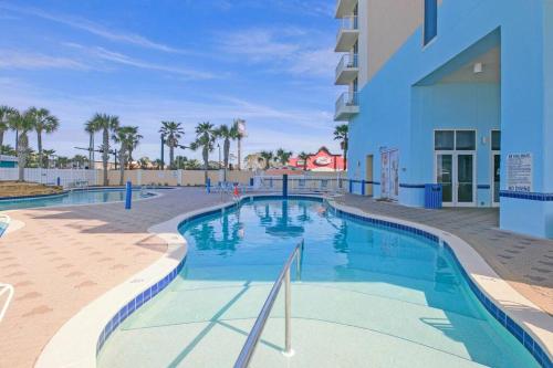 a large swimming pool next to a building at Beachfront Studio #1112 at Majestic in Panama City Beach