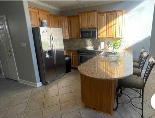 a kitchen with a refrigerator and a table with chairs at P2 - Hot Springs 4 Bedroom Condo in Lake Hamilton