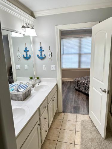 a bathroom with a sink and a mirror at P2 - Hot Springs 4 Bedroom Condo in Lake Hamilton
