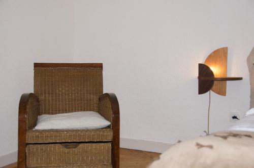 a room with a chair and a lamp and a bed at Maison Georges Couthon in Orcet