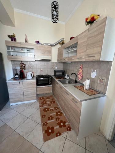 a kitchen with a sink and a counter top at See and City Apartment in Aigio