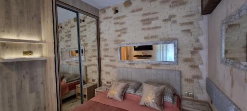 a bedroom with a brick wall and a bed with pillows at Luxury Apartments Seveeu in Warsaw