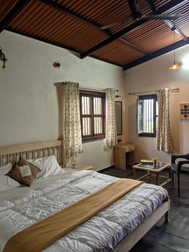 a bedroom with a large bed in a room at Vanacara in Sawantwadi