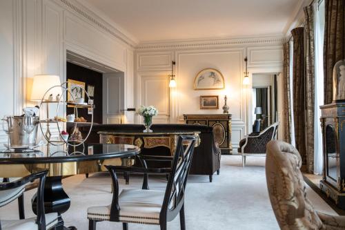 a living room with a table and chairs at La Réserve Paris Hotel & Spa in Paris