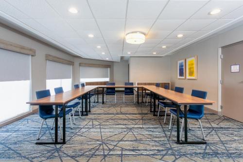 a large conference room with wooden tables and chairs at Holiday Inn Express Hotel Clearwater East - ICOT Center by IHG in Pinellas Park