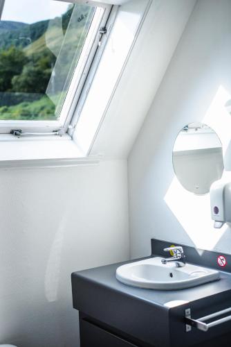 a bathroom with a sink and a window at Lochranza Youth Hostel in Lochranza