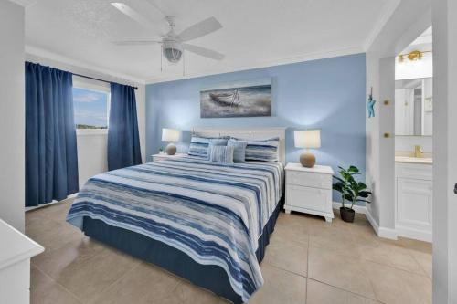 a bedroom with a bed and a blue wall at Oceanfront Condo #507 at Summit Beach Resort in Panama City Beach