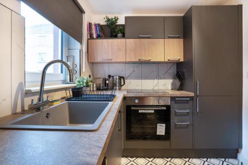 a kitchen with a sink and a counter top at Modern 2BED Apartment-Free Parking in Edinburgh