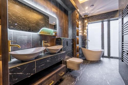 a bathroom with two sinks and two toilets at 34 Coney Street in York