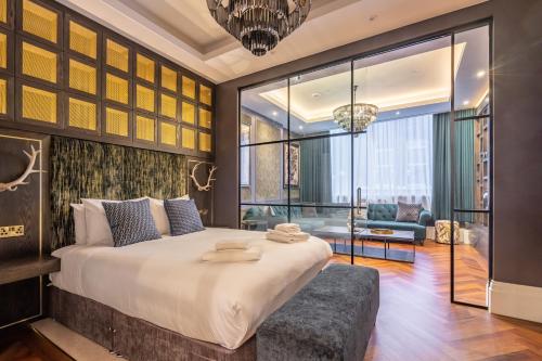 a bedroom with a large bed with a large window at 34 Coney Street in York
