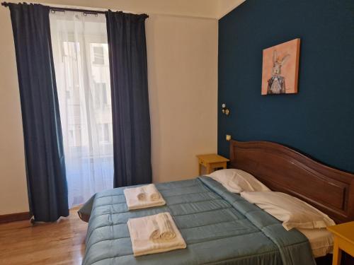 a bedroom with a bed with two towels on it at Pepe's Place - Carlo Alberto in Rome