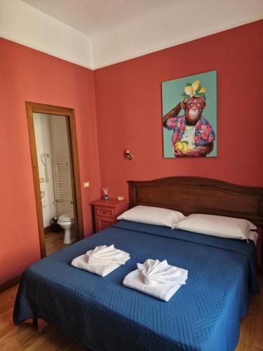 a bedroom with a bed with two towels on it at Pepe's Place - Carlo Alberto in Rome