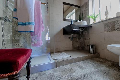 a bathroom with a shower with a tub and a sink at sunrise flats in Mellieħa