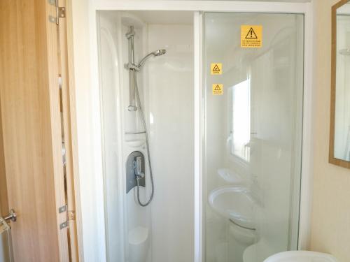 a bathroom with a shower and a toilet and a sink at E10 Eagle Meadows in Paignton