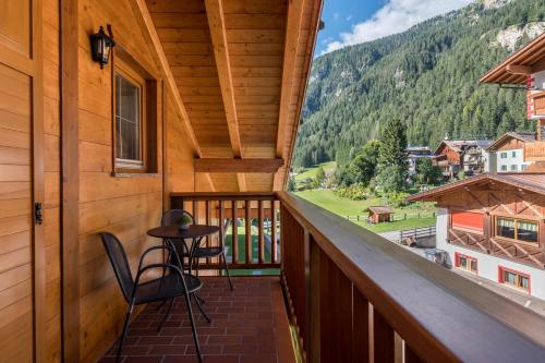 a view from the balcony of a cabin with a table and chairs at Villa Lory 6 in Canazei