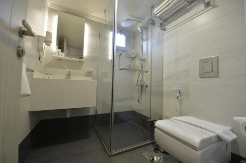 a bathroom with a toilet and a glass shower at Zett hotel in Jounieh