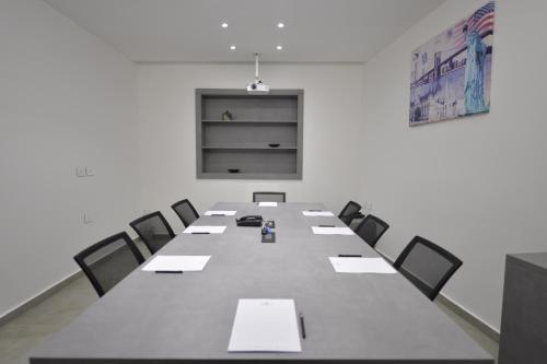 a conference room with a long table and chairs at Zett hotel in Jounieh