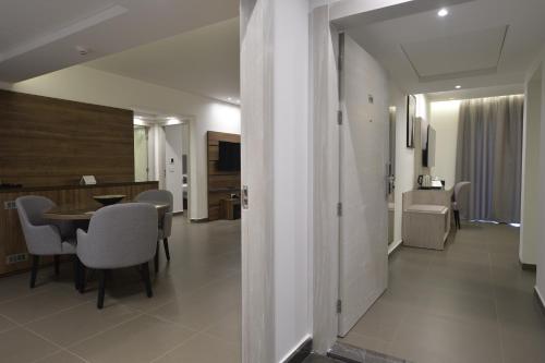 a dining room and living room with a table and chairs at Zett hotel in Jounieh