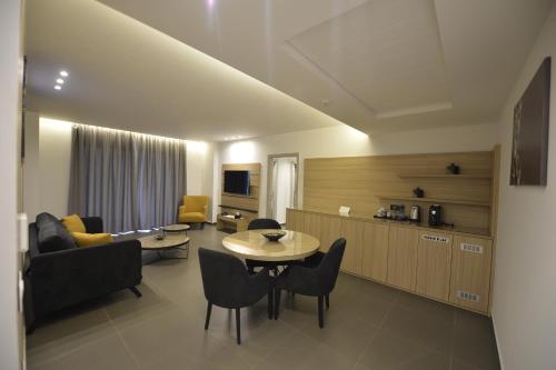 a living room with a couch and a table and chairs at Zett hotel in Jounieh