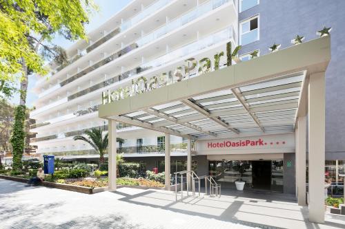 a large white building with a sign for a houston apartment at Hotel Best Oasis Park in Salou
