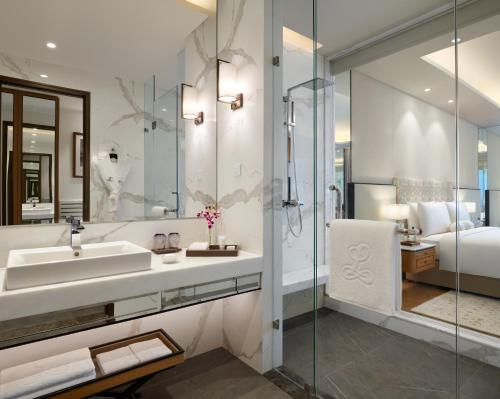 a bathroom with a sink and a mirror at The Leela Bhartiya City Bengaluru in Bengaluru