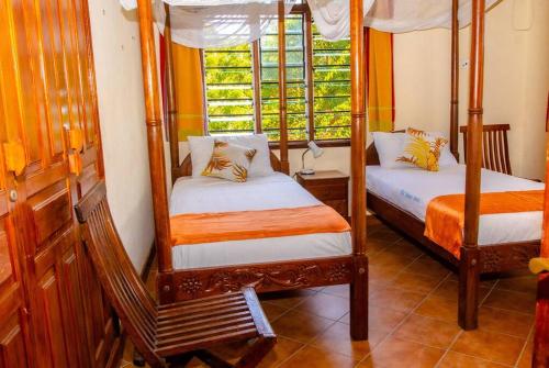 a bedroom with two bunk beds and a window at Sand and Shells Beach House- 4 Bedroom with a pool in Mombasa
