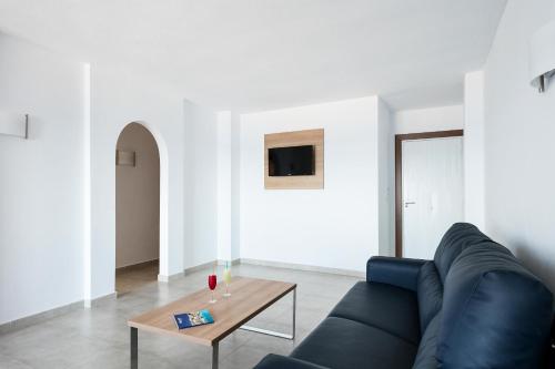 a living room with a couch and a coffee table at Best Club Vacaciones Pueblo Indalo in Mojácar