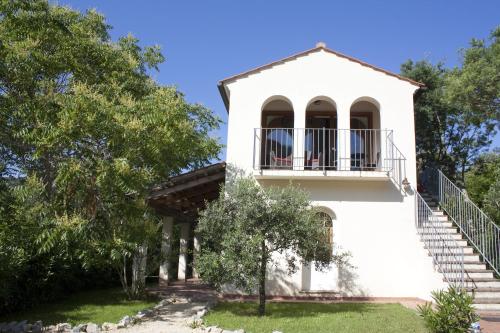 a white house with a balcony and stairs at Hotel Santo Stefano in Portoferraio
