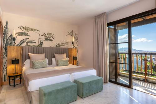 a bedroom with a bed and a balcony at Hotel Suite Villa Maria in Adeje