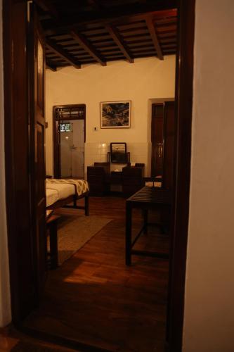 a view of a bedroom with a bed and a table at Vanilla County in Vagamon