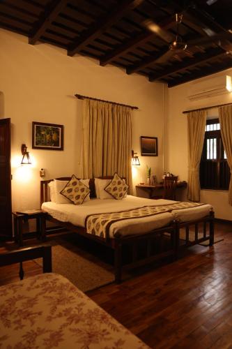 a bedroom with a large bed in a room at Vanilla County Heritage Plantation Bungalow in Vagamon
