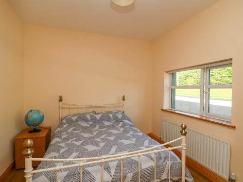 a bedroom with a bed and a window at Valley View in Enniscorthy